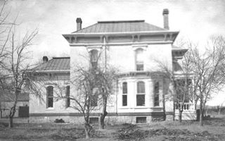 Luna Mansion 1890s two story mansion, trees, black and white 1890s