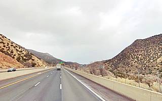 Looking east towards Tijeras, hills surround freeway highway, truck ahead