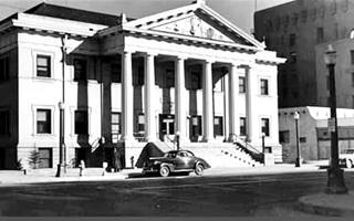 Masonic Temple ABQ c.1940s black and white 1940s building with columns like a Greek Temple, car parked on Route 66 in front of it