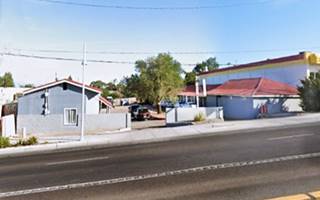 color street view of a former 1 story motel seen from Rte 66