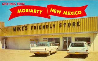 Mike’s Friendly Store 1960s, Moriarty US66 yellow sheet metal faced store, signs on it, cars parked