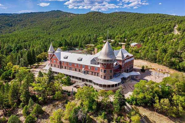 Castle in a forest and hills setting seen from above