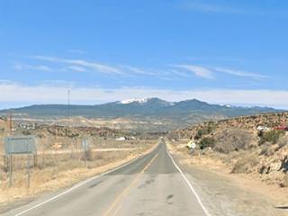 Mount Taylor seen from Route 66, Paraje NM snowcapped mountain in the distance, Route 66 runs towards it