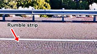 musical highway Carnuel rumble strip on roadway, guardrail and bushes behind