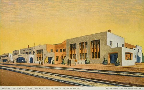 1930 painted postcard. Magnificent hotel, 2 stories dwarfs people on the train station platform. Pueblo air to it, Spanish Mission style too