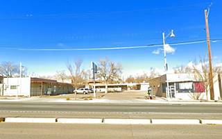 color street view of a former 1 story motel flat roof