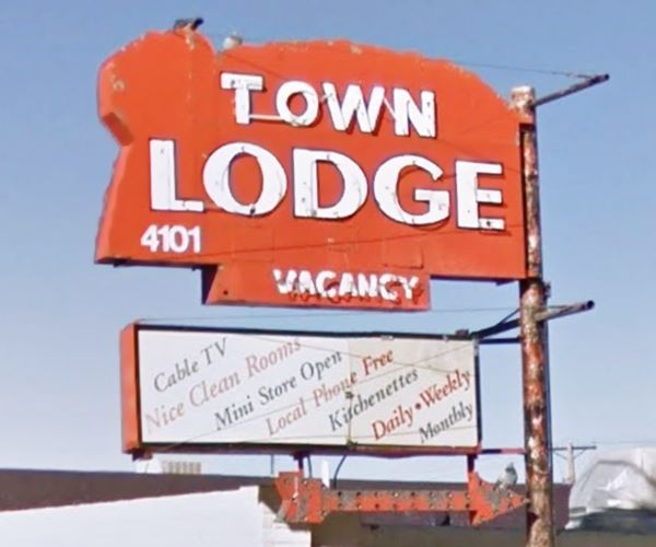neon sign in red with white letters, rounded shape, TOWN LODGE MOTEL