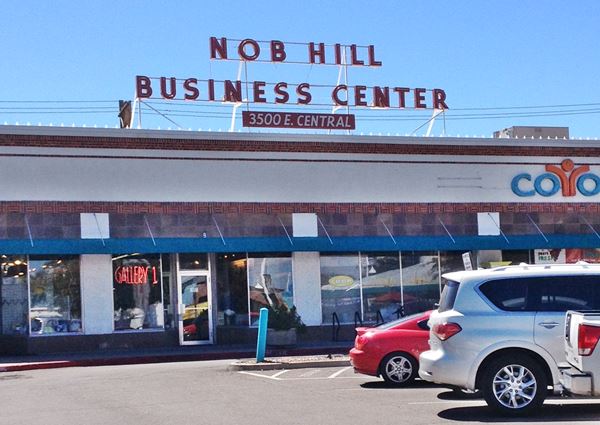 sign over flat roofed building, a mall, with its name NOB HILL BUSINESS CENTER, and address