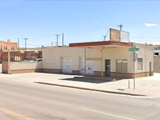 corner gas station built 1948, 2 service bays left, flat canopy, office right, box shaped, 1 story