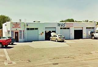 long, single story, multiple service bays, old gas station with corner office