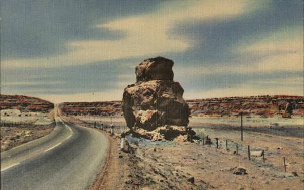 Owl Rock 1940s postcard Mesita NM color linnen postcard, US 66 runs on the left side and a large owl-shaped rock on shoulder to the right, cliffs beyond