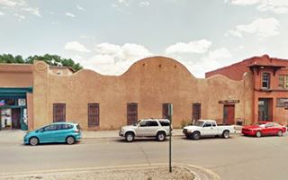 brown adobe wavy parapet building