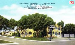 1940s postcard Park Lane Hotel US66 ABQ 1940s color linnen postcard: trees and park, and a two story yellow building on a corner, neon sign faces Route 66