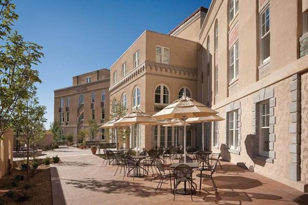 Parq Hotel Albuquerque book your room here Patio by an Italian Villa-styled building, mansion like, with tables and sunshades