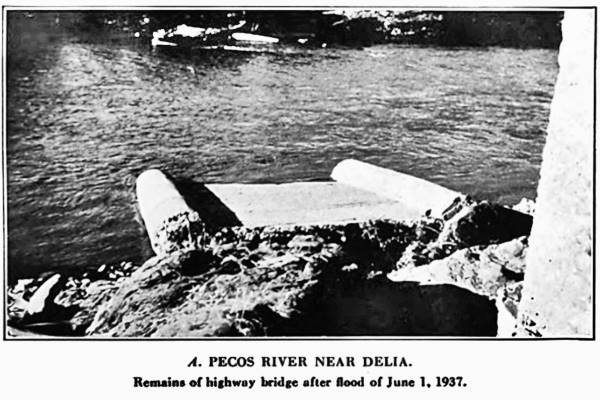 black and white bridge pillars in the water Pecos River runs across the image