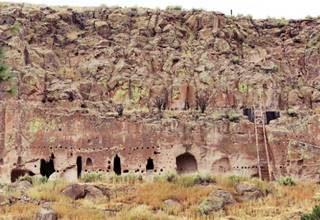 Puye Cliffs Pueblo cave dwellings on a cliff, entrances and a ladder
