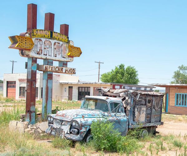 Rusty 1950s pick up truck next to an old rusy neon sign on Route 66 Tucumcari