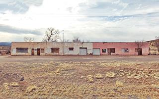 long, single story vacant building slowly decaying