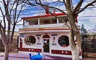 Red Ball Cafe nowadays two story building, round windows on each side of door, trees on the sidewalk words WIMPY’S CAFE written on facade