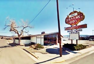 Roarin 20s restaurant in 2009, Grants NM color picture corner restaurant, single floor, gable roof, vacant, neon sign red and yellow by main street (US66)