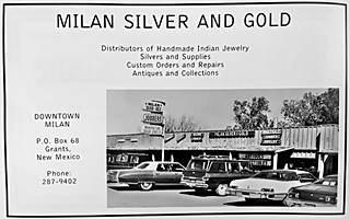 former Silver and Gold Store in Milan NM nowadays black and white 1971 advertisement of a trading post, text and photograph: wood clad building, one story, cars and neon sign