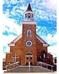 St Anthony church Pecos NM gable roof single central steeple, red stone church