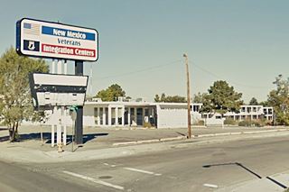 motel, neon sign on corner (left) by Route 66 seen in 2011