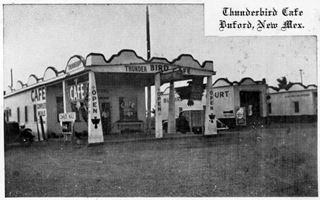 thumbnail Buford Courts and Thunderbird cafe 1930s Moriarty US66 black and white view of a cafe, man, with pedimented parapets on canopy held up by pyramidal pillars, another building and 1930s car (right) words Court written on it