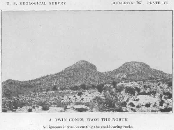 black and white view of two cones on a hill, arid scenery, shrubs taken in 1925