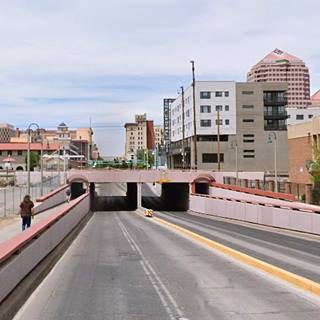 Color view of an uderpass, two lanes go, two return, and buildings around it