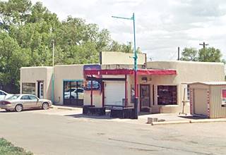 Moderne style gas station, vacant pumps, corner office with curved multipane window, flat canopy
