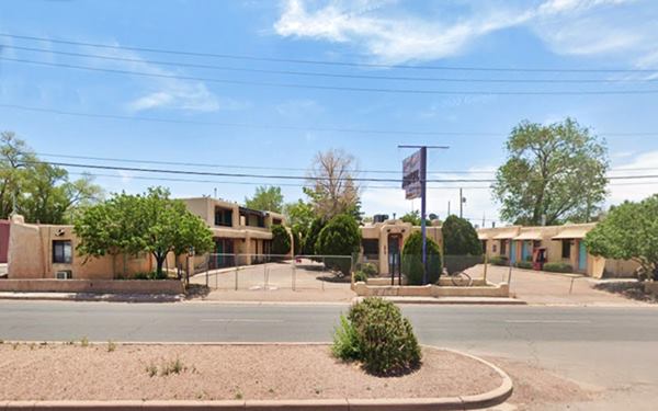 adob Pueblo sytle motel seen from an avenue
