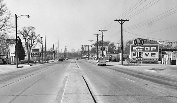3400 block of Sapulpa Rd. 1950s West Tulsa 1950 black and white: four lane highway (US66) concrete median, gas stations left and right, motel left, cars. Cable tower in the distance