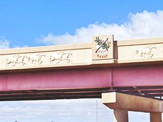 artistic parapet with carved galloping horses on freeway bride