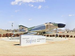 jet fighter plane by museum entrance sign