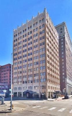 old Adams hotel Tulsa nowadays corner building bricks, decorated stone and stone cornice