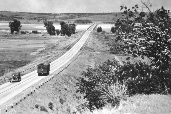 US highway 66, cars and the steel bridge in a 1930s black and white photo