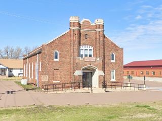 red brick simple and austere former Catholic Church