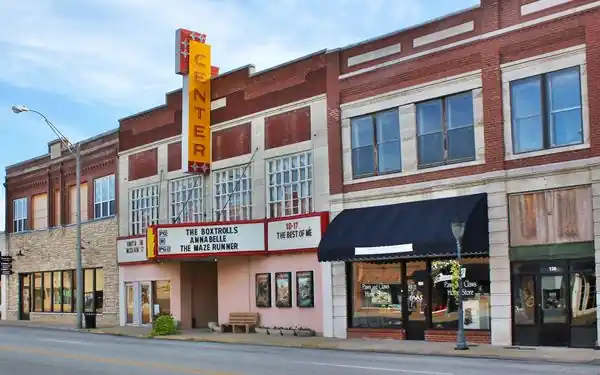 facade, marquee of theater, red brick buildings next to it