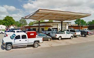 Clinton Sinclair gas station, and cars