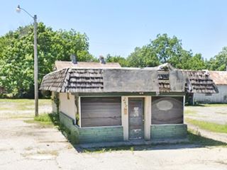 abandoned mansard shingle roofed box shaped diner