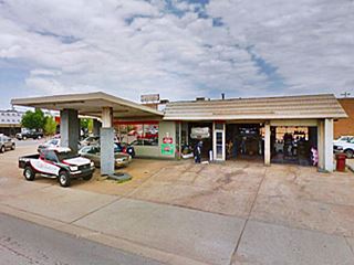 Conoco station on Route 66 old station used as a garage, with cars and two canopies