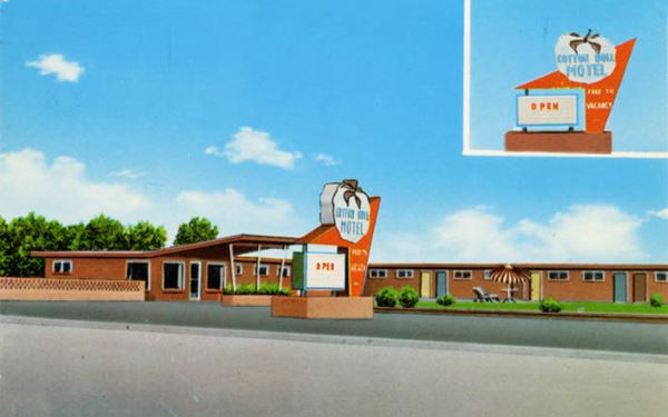 1960s color postcard of the motel and its neon sign