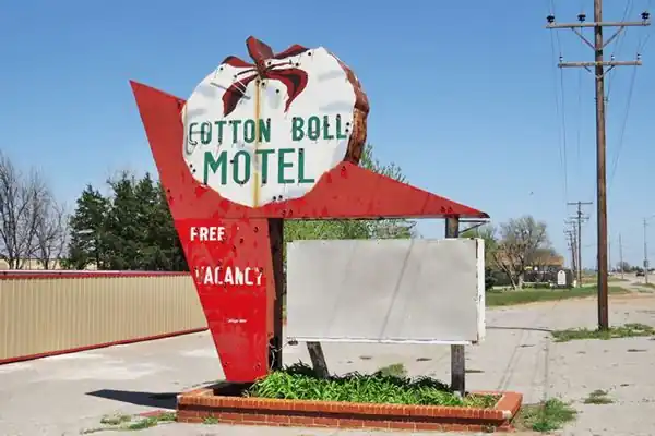 Vintage 1950s motel neon sign with large cotton ball on a red arrow