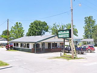 building with green neon sign and cars, a restaurant on US66