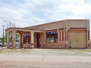 Depew 1920s filling station canopy over pump islands and gas station on a corner