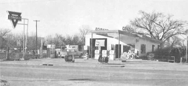 black and white photo of a Conoco gas station from 1966