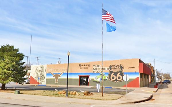 Route 66 shield, longhorn, vintage pick up truck, and Jesse Chisholm face in a mural