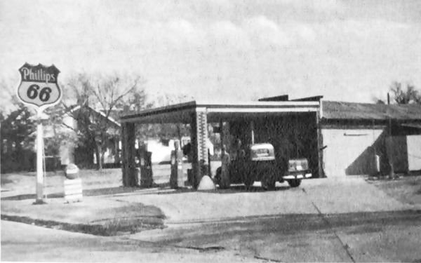 black and white picture gas station on a corner, Phillips66 sign, pick-up and gas pumps
