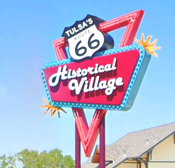 Tulsa’s Route 66 Historical Village neon sign retro vintage neon sign reads HISTORICAL VILLAGE with US 66 shield has yellow stars, red triangle, red panel with blue outline and light bulbs